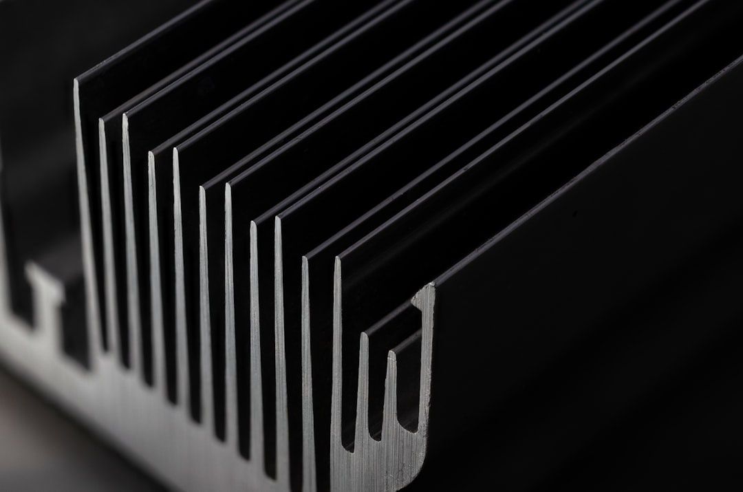 Close-up of stacked black metal plates forming an intercooler core
