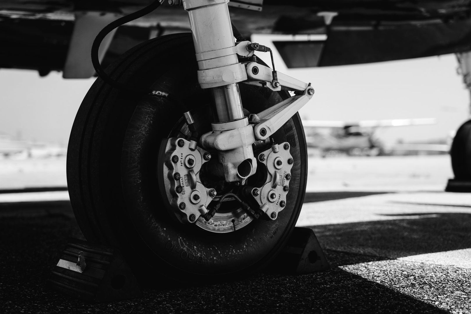 Close-up of an aircraft wheel with twin brake calipers and disc