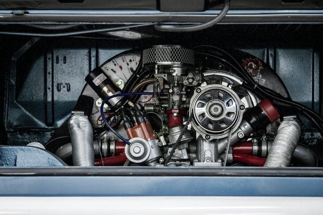 Exposed rear-mounted petrol engine with carburetor and ignition components